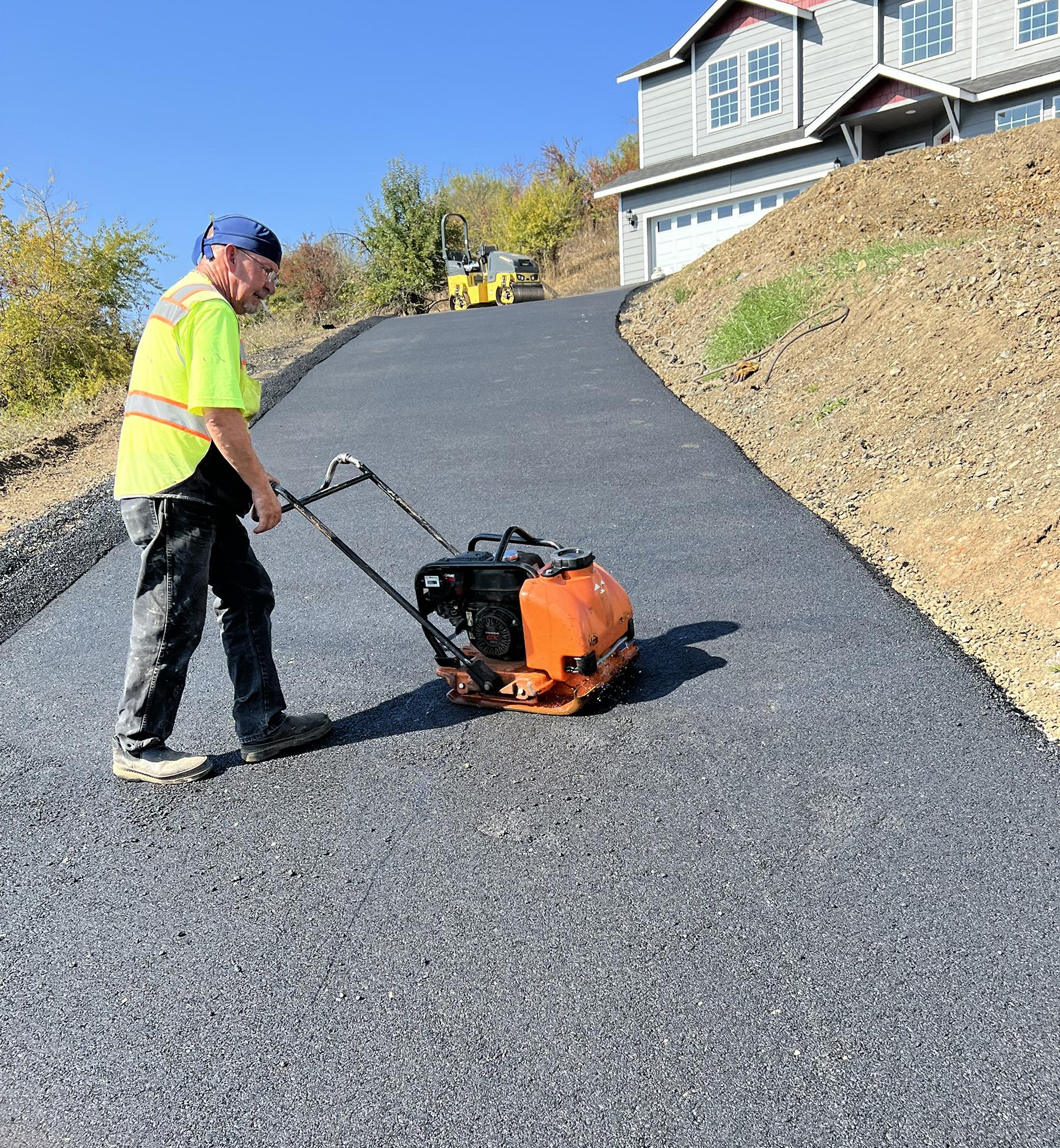 Custom Asphalt Driveway - Worker using machine