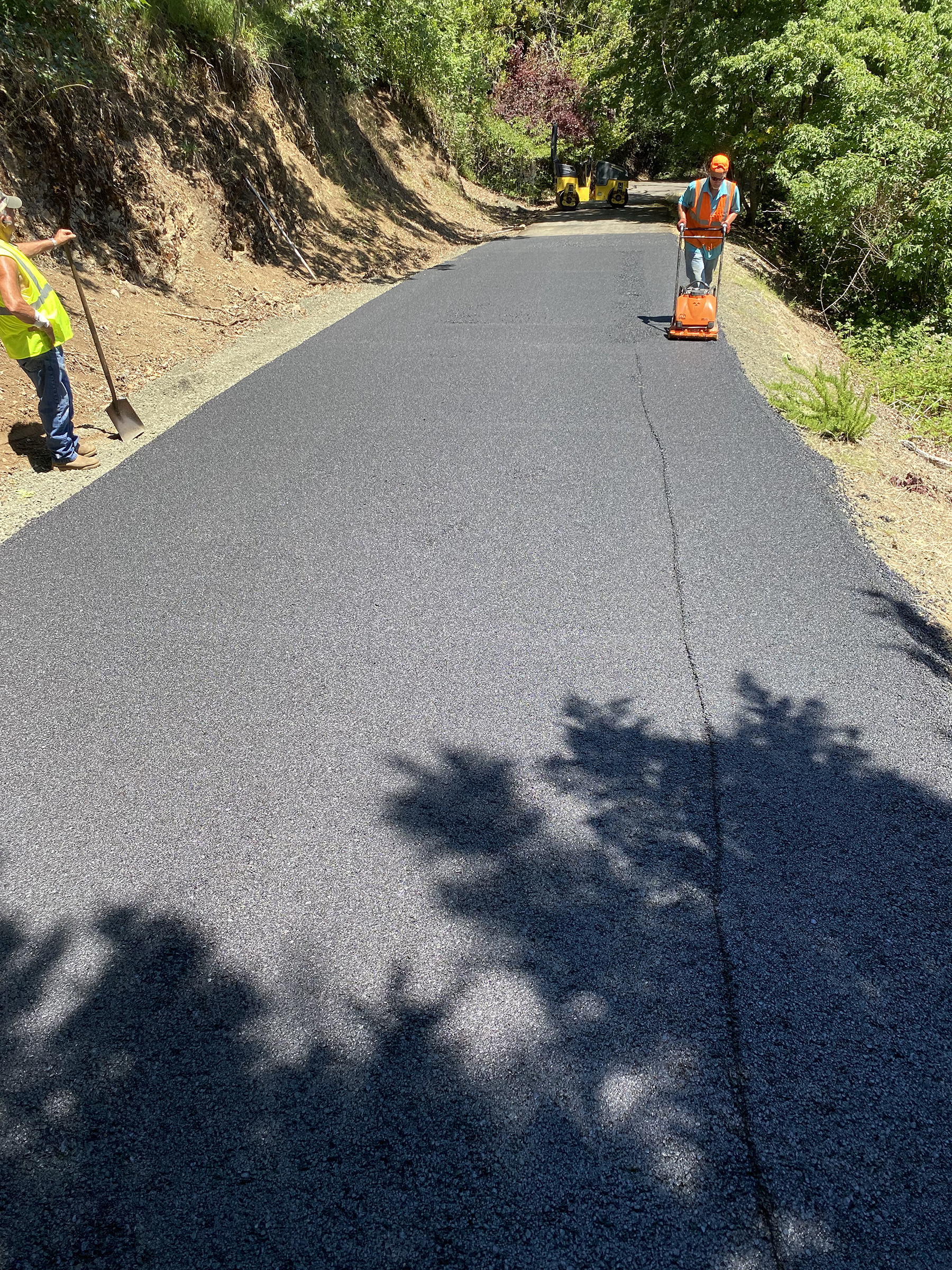 Custom Asphalt Paving - Man pushing Machine